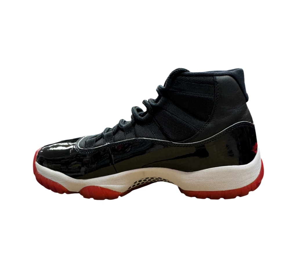 Genesis Boutique pre-owned Jordan 11 Bred 2019 sneakers featuring black patent leather and a red translucent outsole.