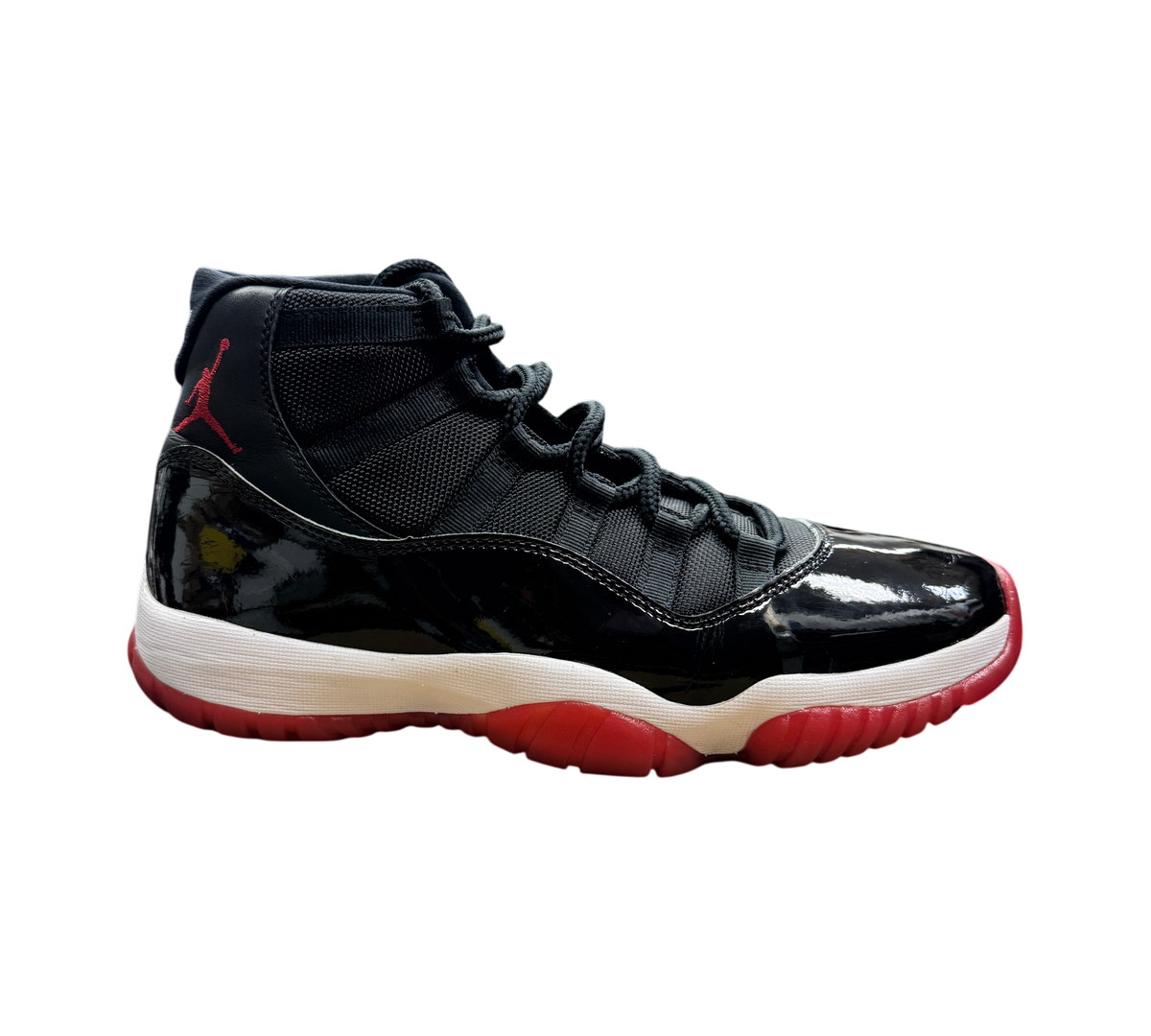 Genesis Boutique pre-owned Jordan 11 Bred 2019 sneakers featuring black patent leather and red translucent outsole.