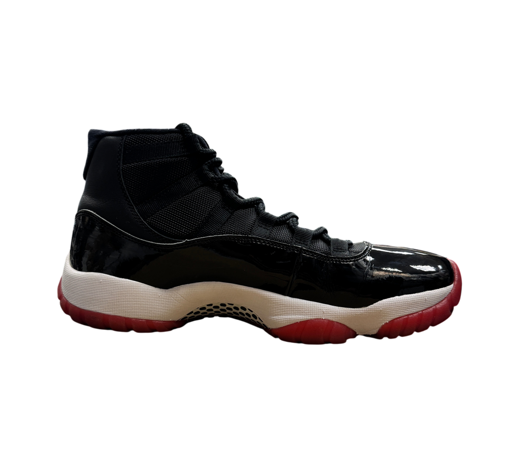 Genesis Boutique pre-owned Jordan 11 Bred 2019 sneakers featuring black mesh, patent leather, and a red translucent sole.