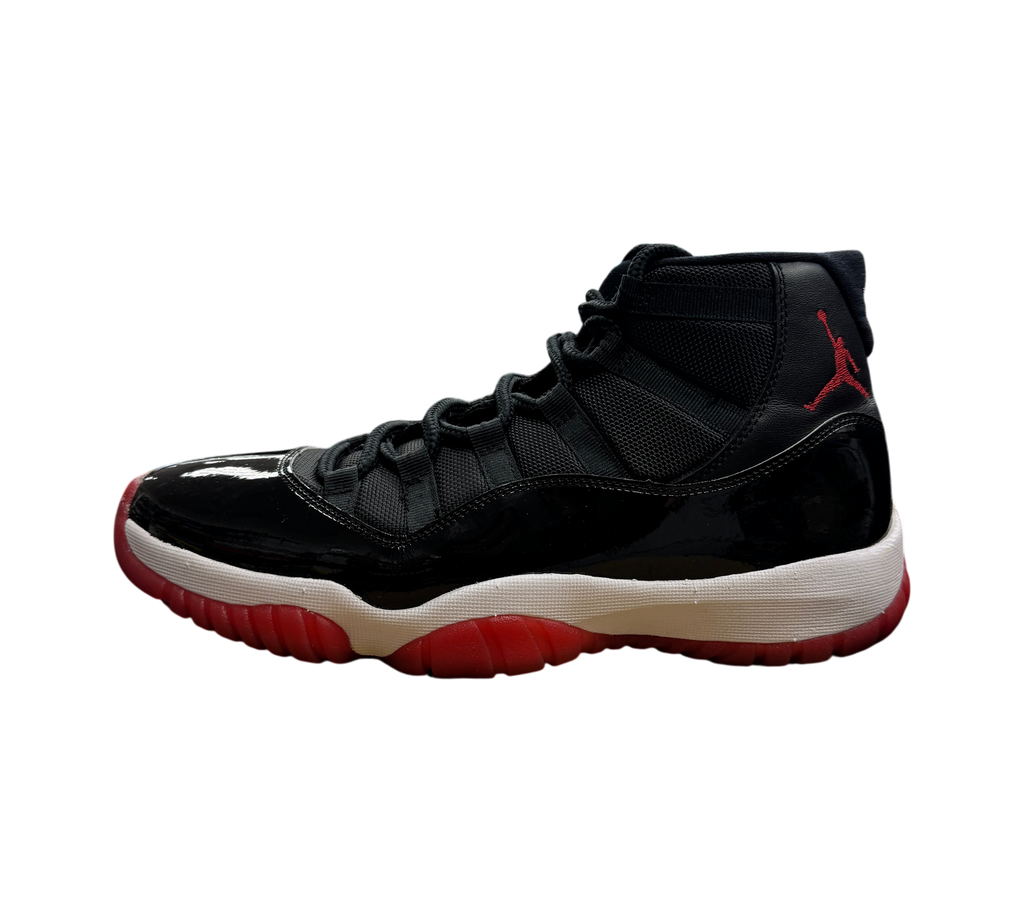 Genesis Boutique pre-owned Jordan 11 Bred 2019 sneakers featuring black patent leather, mesh upper, and red outsole.