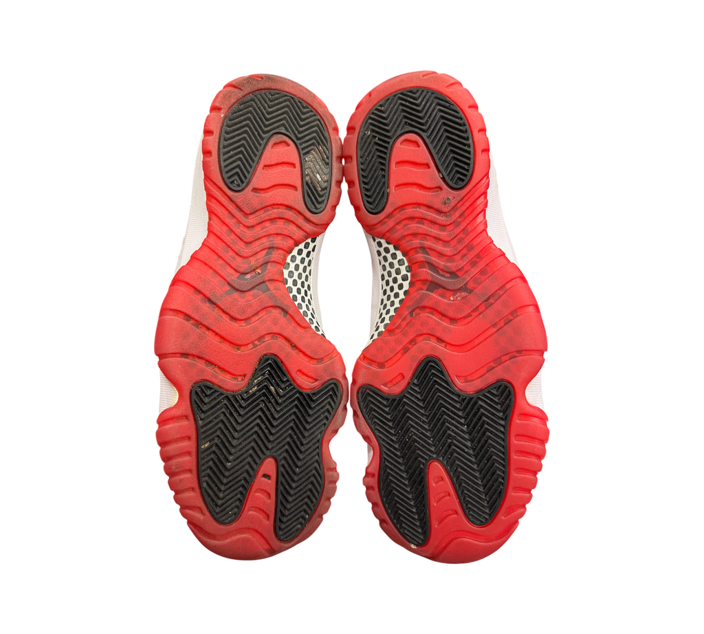 Genesis Boutique used Jordan 11 Bred 2019 sneakers showing the red and black rubber outsoles with carbon fiber plate.
