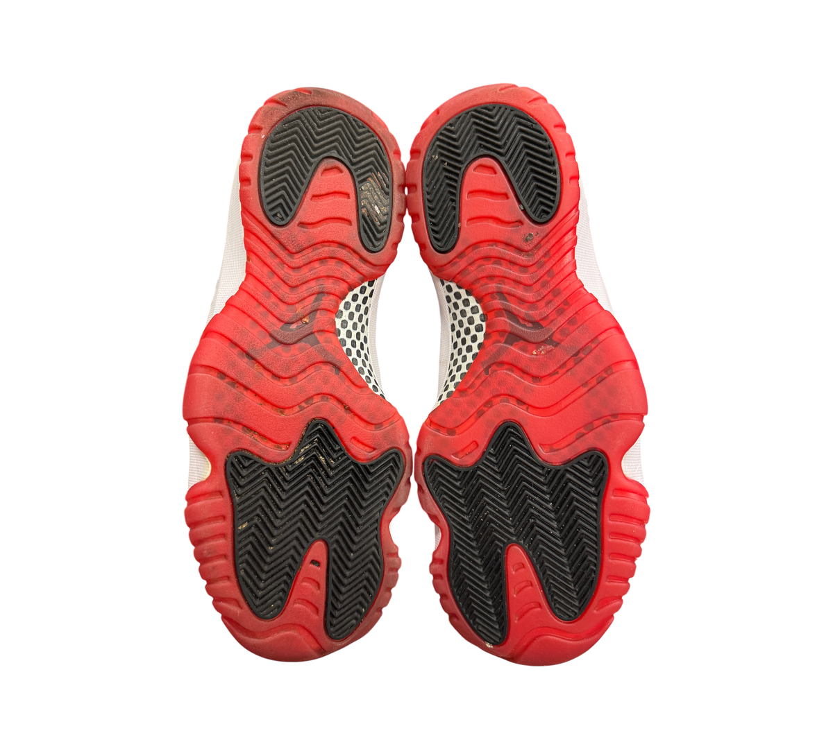 Genesis Boutique used Jordan 11 Bred 2019 sneakers showing the red and black rubber outsoles with carbon fiber plate.