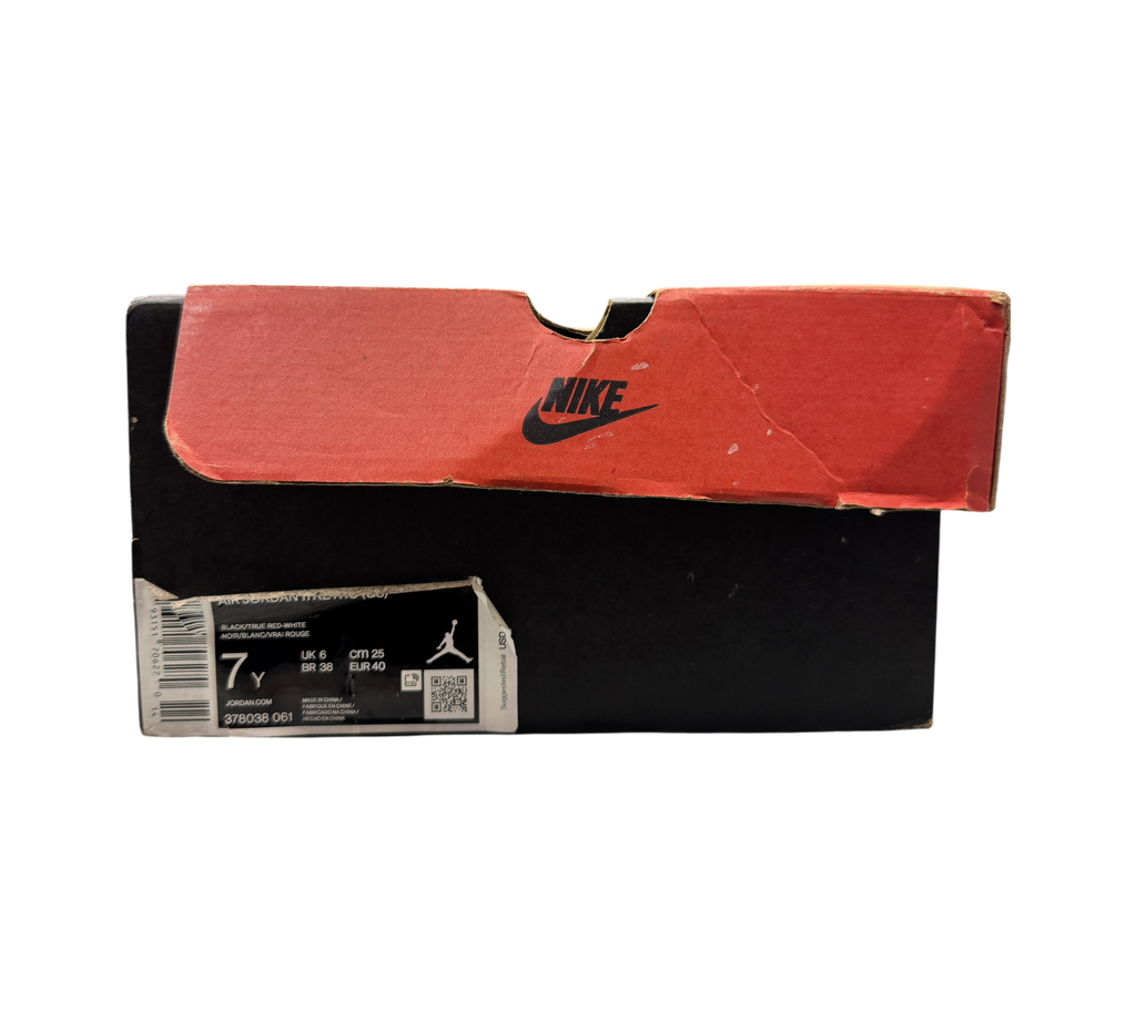 Genesis Boutique Jordan 11 GS Bred shoe box with red lid and size label in a retail store setting
