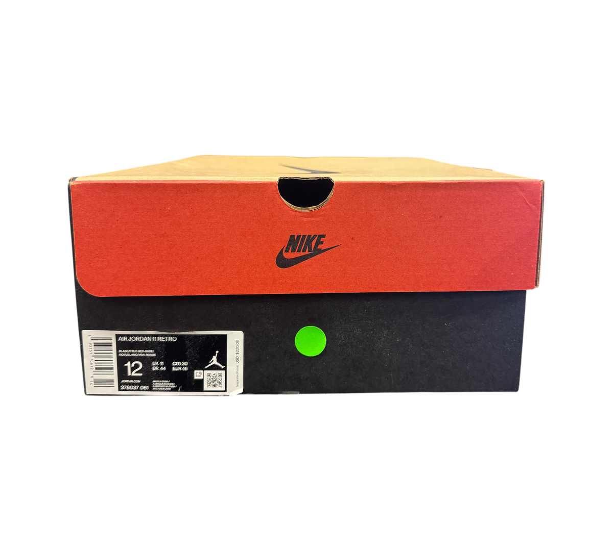 Genesis Boutique Jordan 11 Bred sneaker box with Nike branding and size 12 label against a wall of stacked shoe boxes