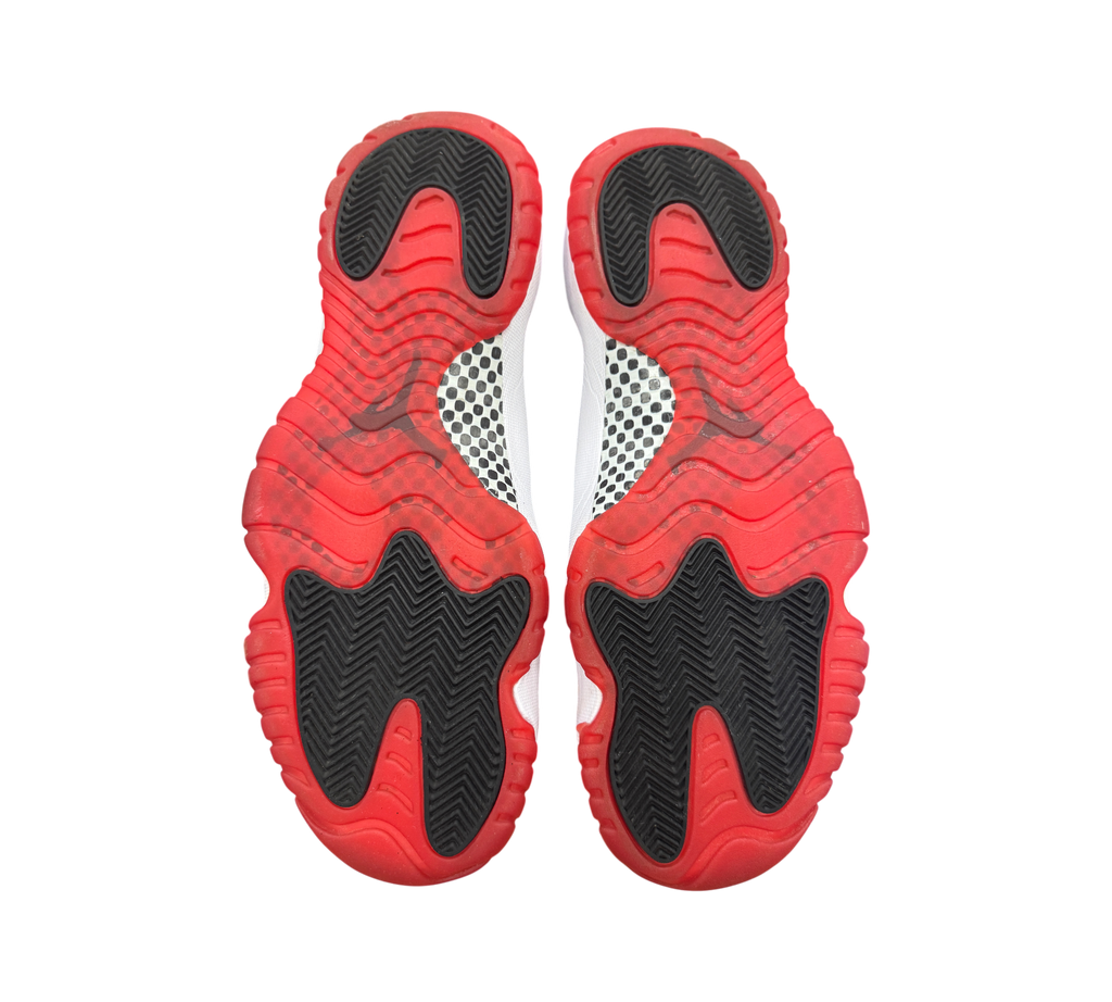 Genesis Boutique used Jordan 11 Bred sneakers showing the red and black rubber outsoles with carbon fiber plate detail