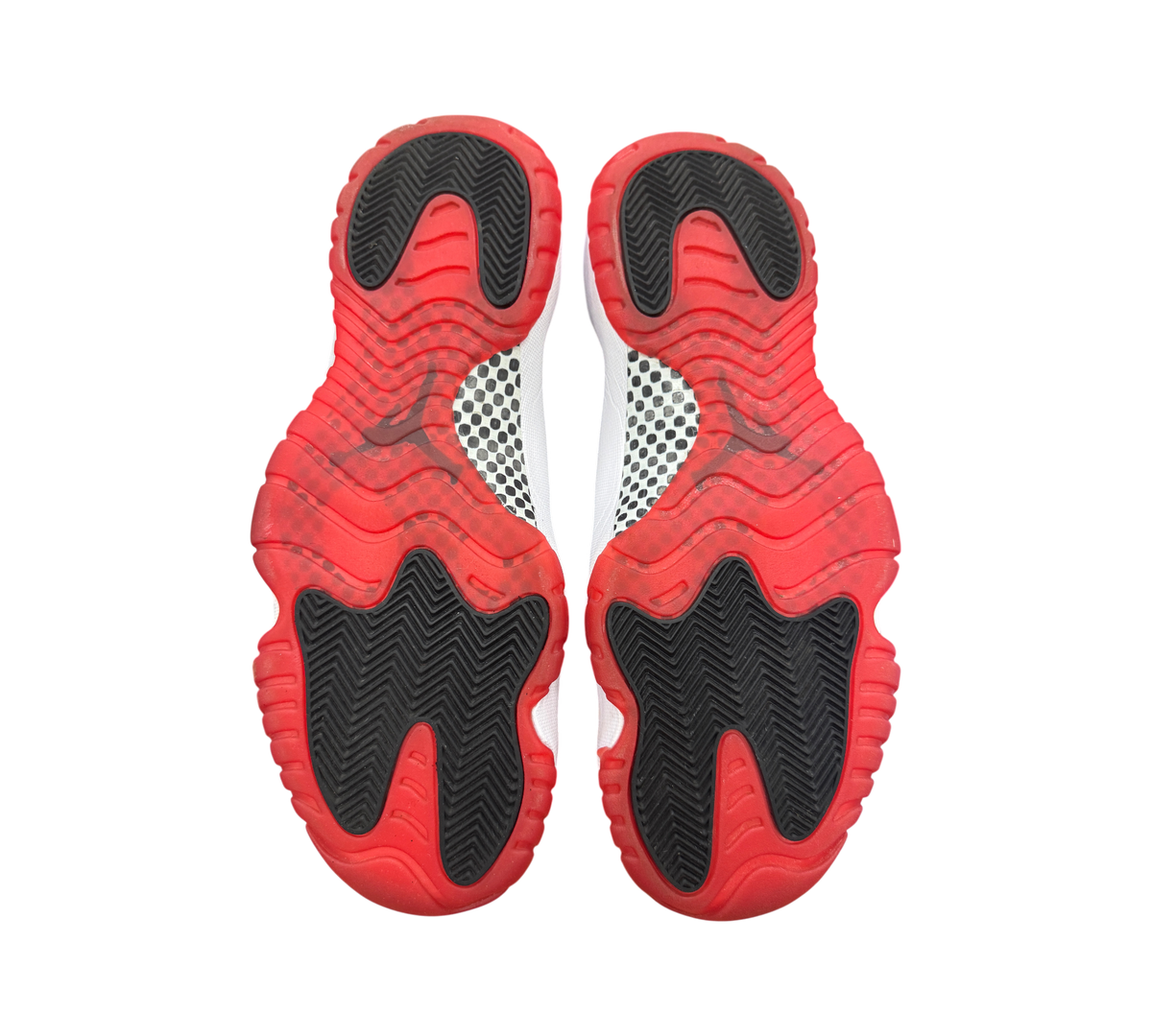 Genesis Boutique used Jordan 11 Bred sneakers showing the red and black rubber outsoles with carbon fiber plate detail