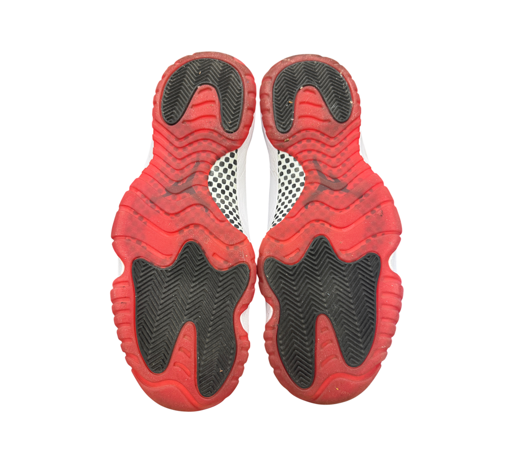 Genesis Boutique used Jordan 11 Bred 2019 sneakers showing red and black rubber outsoles with carbon fiber plate detail