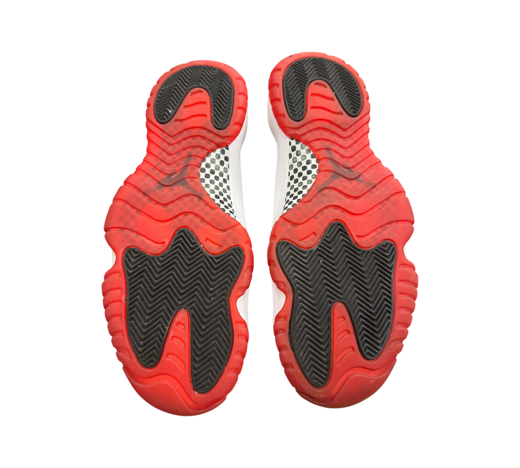Genesis Boutique used Jordan 11 Bred 2019 sneakers showing the red and black rubber outsoles with carbon fiber plate