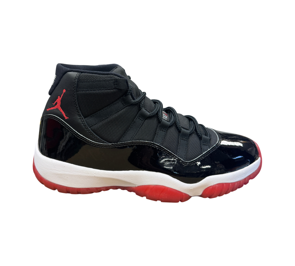Genesis Boutique Jordan 11 Bred sneaker in black patent leather and mesh with a red translucent outsole