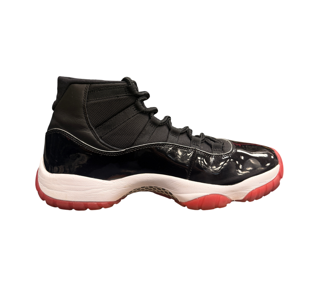 Genesis Boutique Jordan 11 2019 Bred sneakers with black patent leather, white midsole, and red outsole.