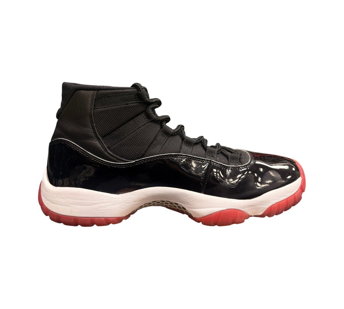 Genesis Boutique Jordan 11 2019 Bred sneakers with black patent leather, white midsole, and red outsole.