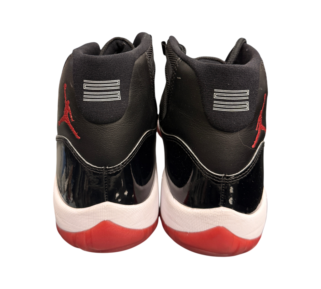 Genesis Boutique Jordan 11 2019 Bred sneakers with black patent leather, red accents, and white midsole.