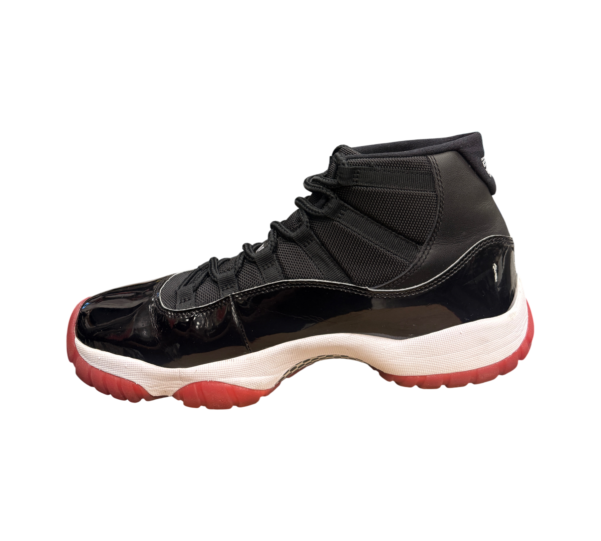 Genesis Boutique Jordan 11 2019 Bred sneakers with black patent leather, red accents, and white midsole.