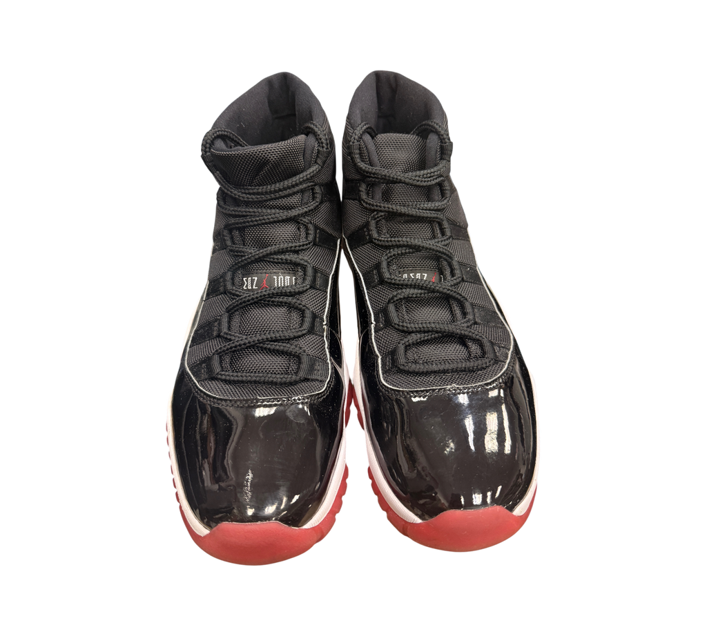 Genesis Boutique USED Jordan 11 2019 Bred sneakers with black patent leather, red soles, and white accents.