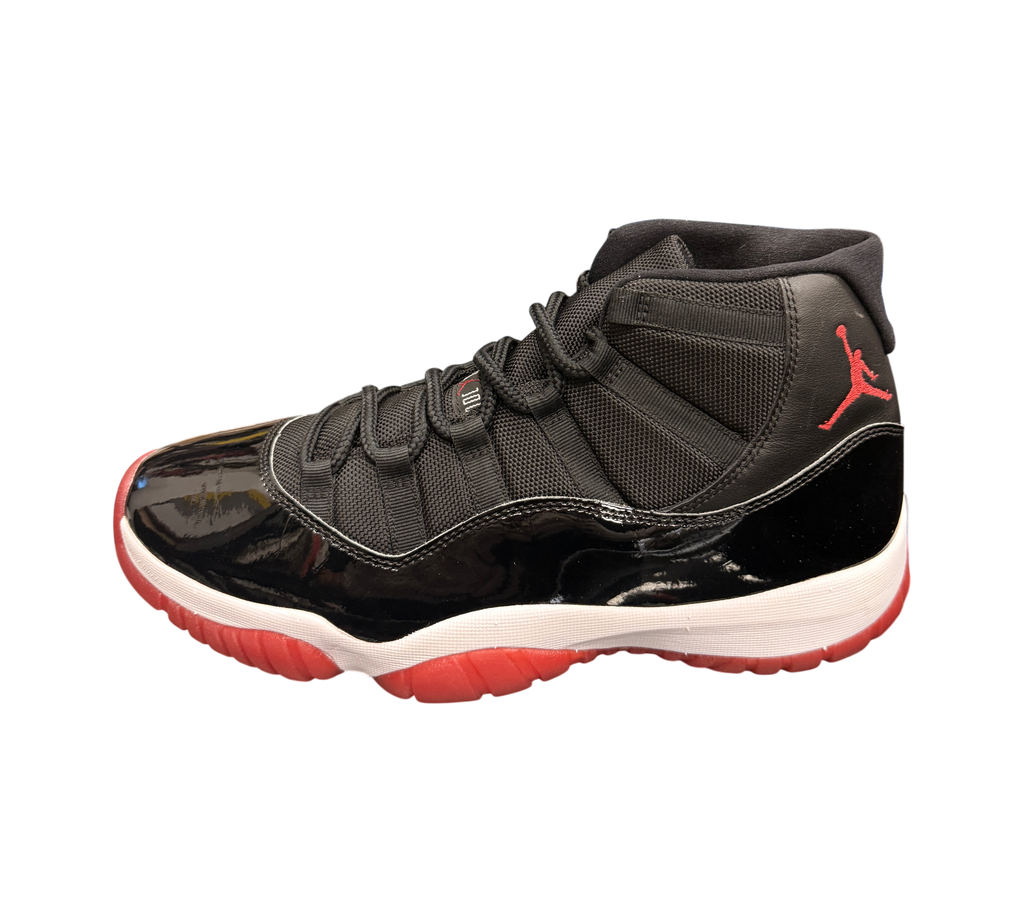 Genesis Boutique Jordan 11 2019 Bred sneakers with black mesh and patent leather, white midsole, and red outsole.