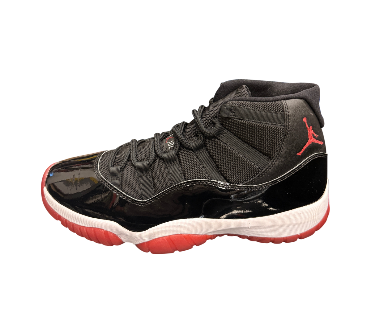 Genesis Boutique Jordan 11 2019 Bred sneakers with black mesh and patent leather, white midsole, and red outsole.