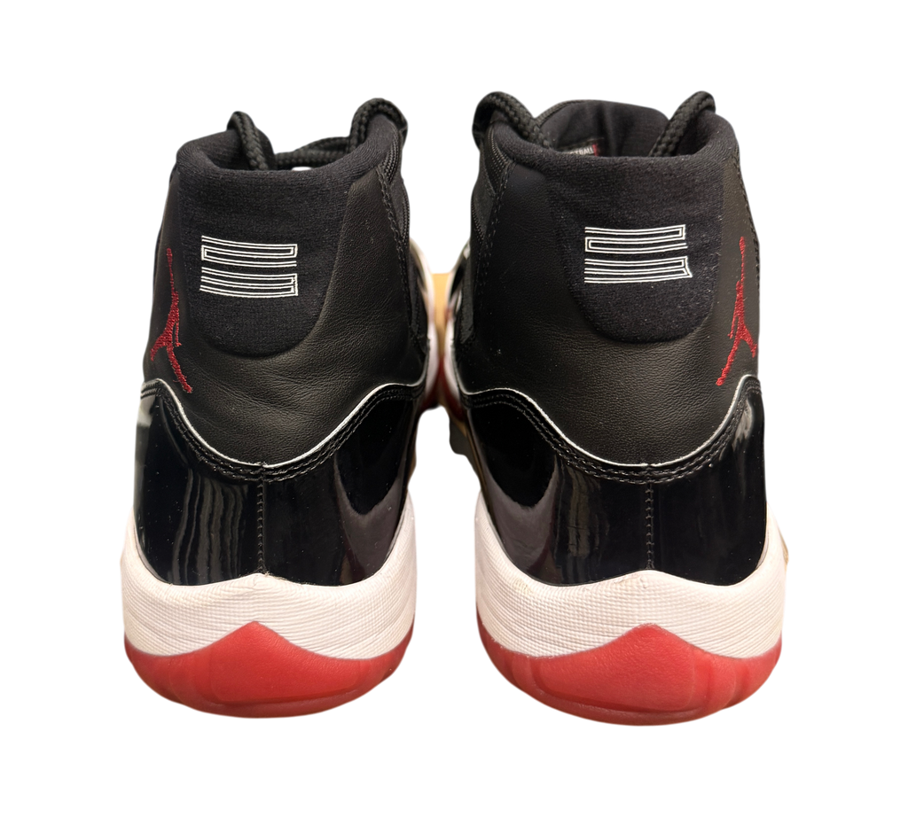 Genesis Boutique Jordan 11 2019 Bred sneakers with black patent leather, red accents, and white midsole.