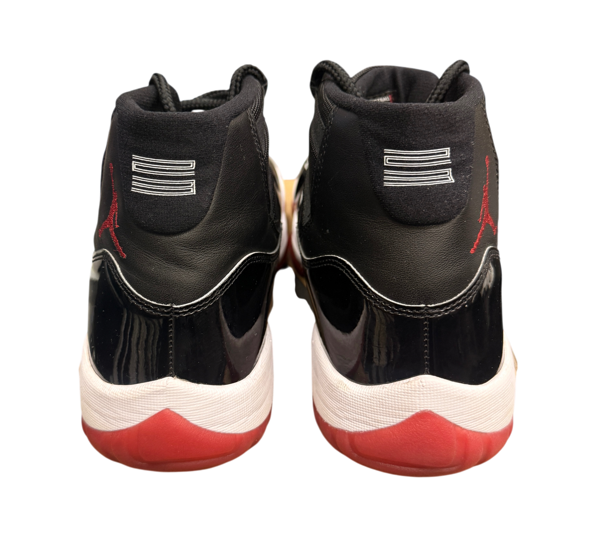 Genesis Boutique Jordan 11 2019 Bred sneakers with black patent leather, red accents, and white midsole.