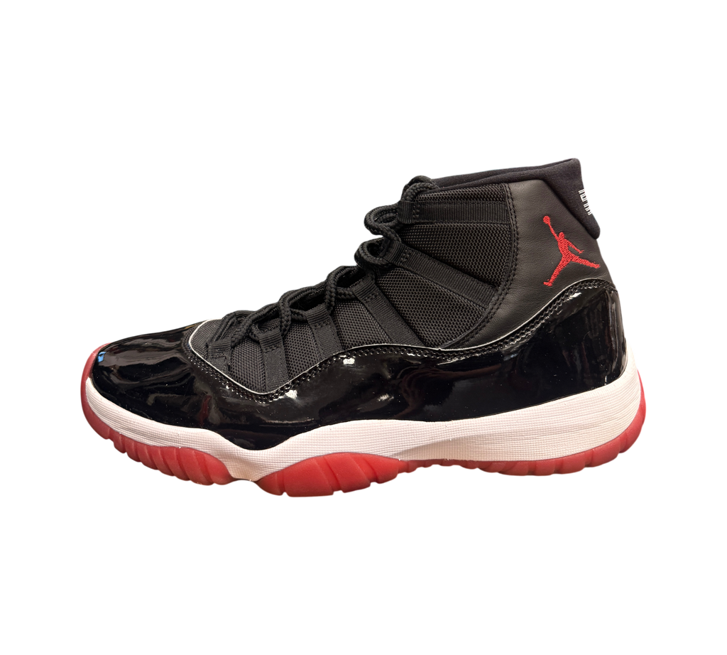 Genesis Boutique Jordan 11 2019 Bred sneakers with black patent leather, red accents, and white midsole.