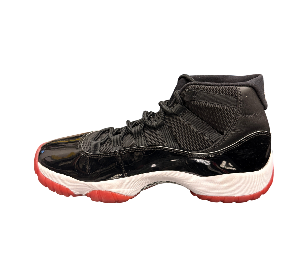 Genesis Boutique Jordan 11 2019 Bred sneakers with black patent leather, red outsole, and white midsole.