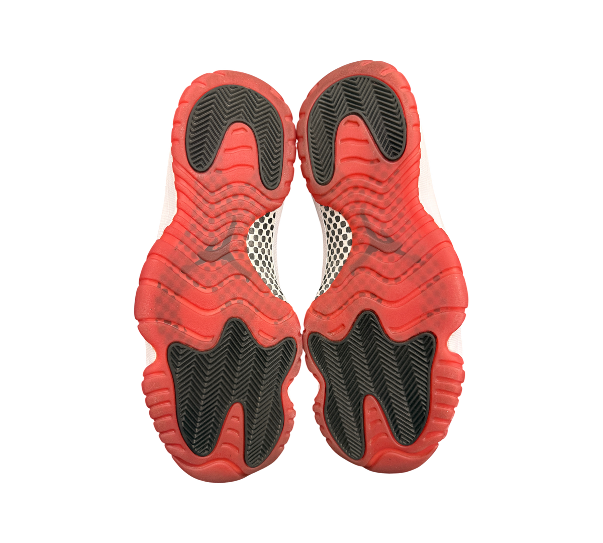 Genesis Boutique Jordan 11 2019 Bred sneakers feature red and black rubber soles with white accents.
