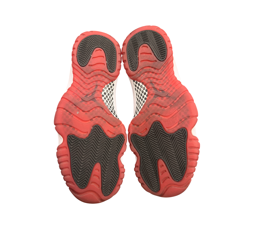 Genesis Boutique Jordan 11 2019 Bred sneakers, red and black rubber soles with white accents.