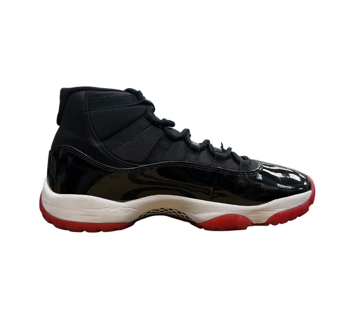 Genesis Boutique Jordan 11 Bred 2019 sneakers in black patent leather and mesh with a red translucent outsole