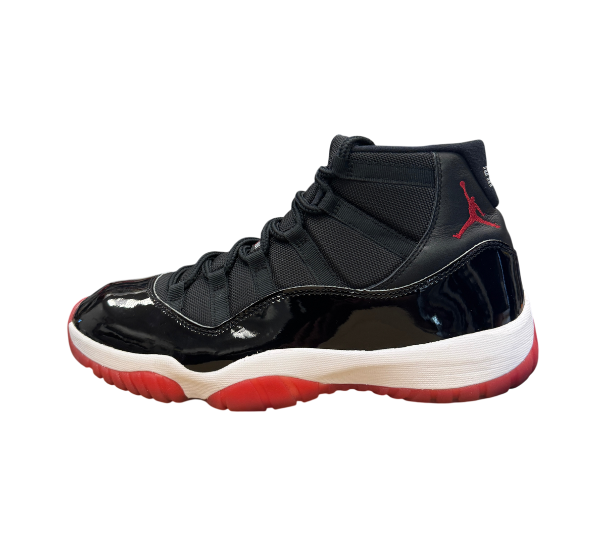 Genesis Boutique Jordan 11 Bred 2019 sneakers in black patent leather and mesh with red accents and white midsole