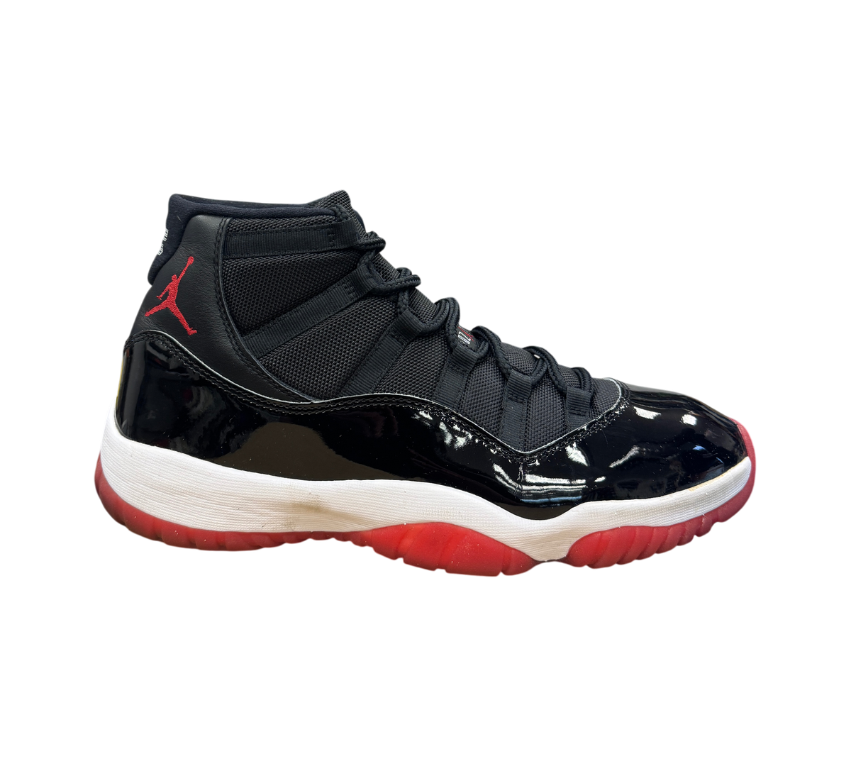 Genesis Boutique Jordan 11 Bred 2019 sneakers in black patent leather with red accents and white midsole