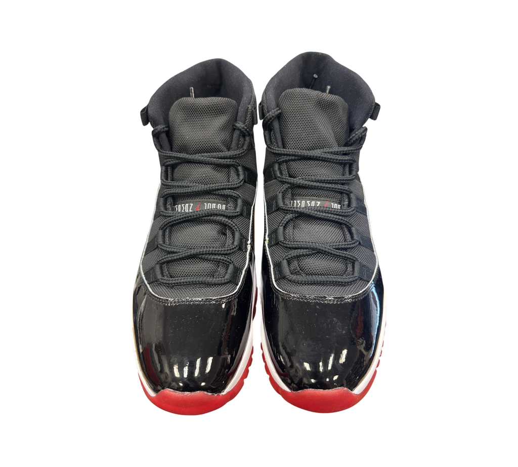Genesis Boutique Jordan 11 Bred sneakers in black and red with signature patent leather mudguard and mesh upper
