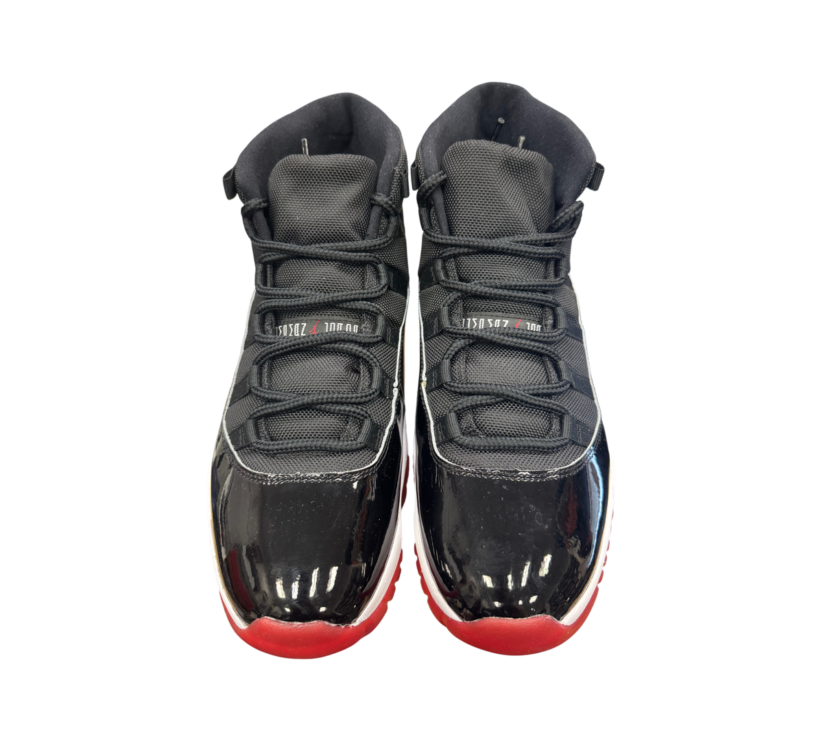 Genesis Boutique Jordan 11 Bred sneakers in black and red with signature patent leather mudguard and mesh upper