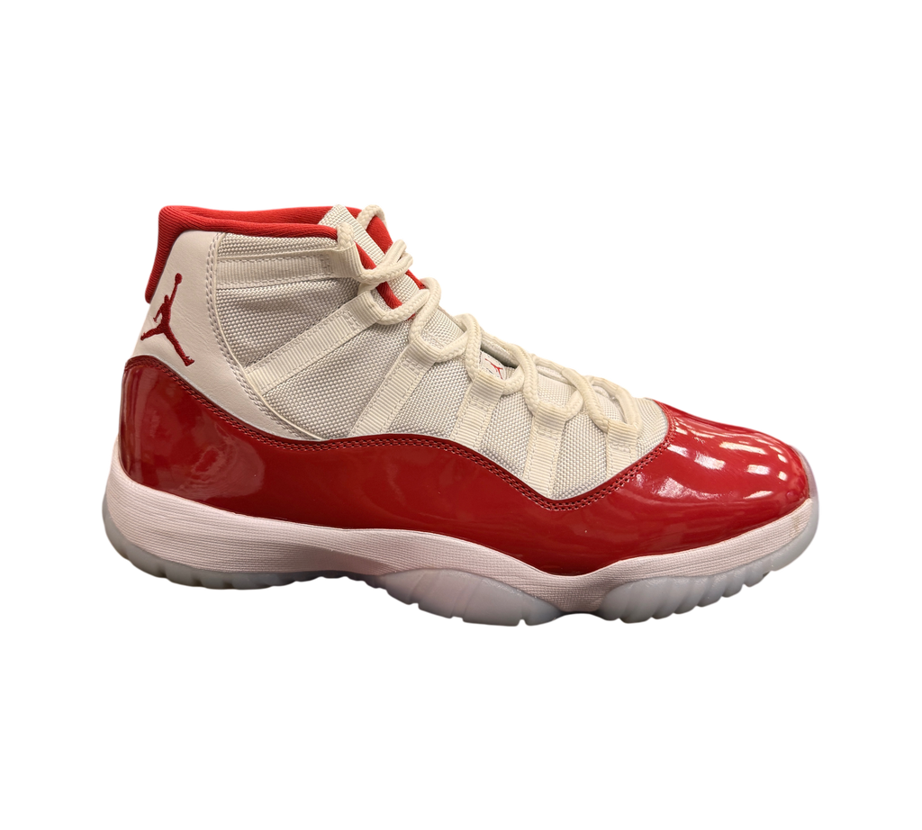 Genesis Boutique pre-owned Jordan 11 Cherry sneakers featuring white mesh, red patent leather, and translucent soles.