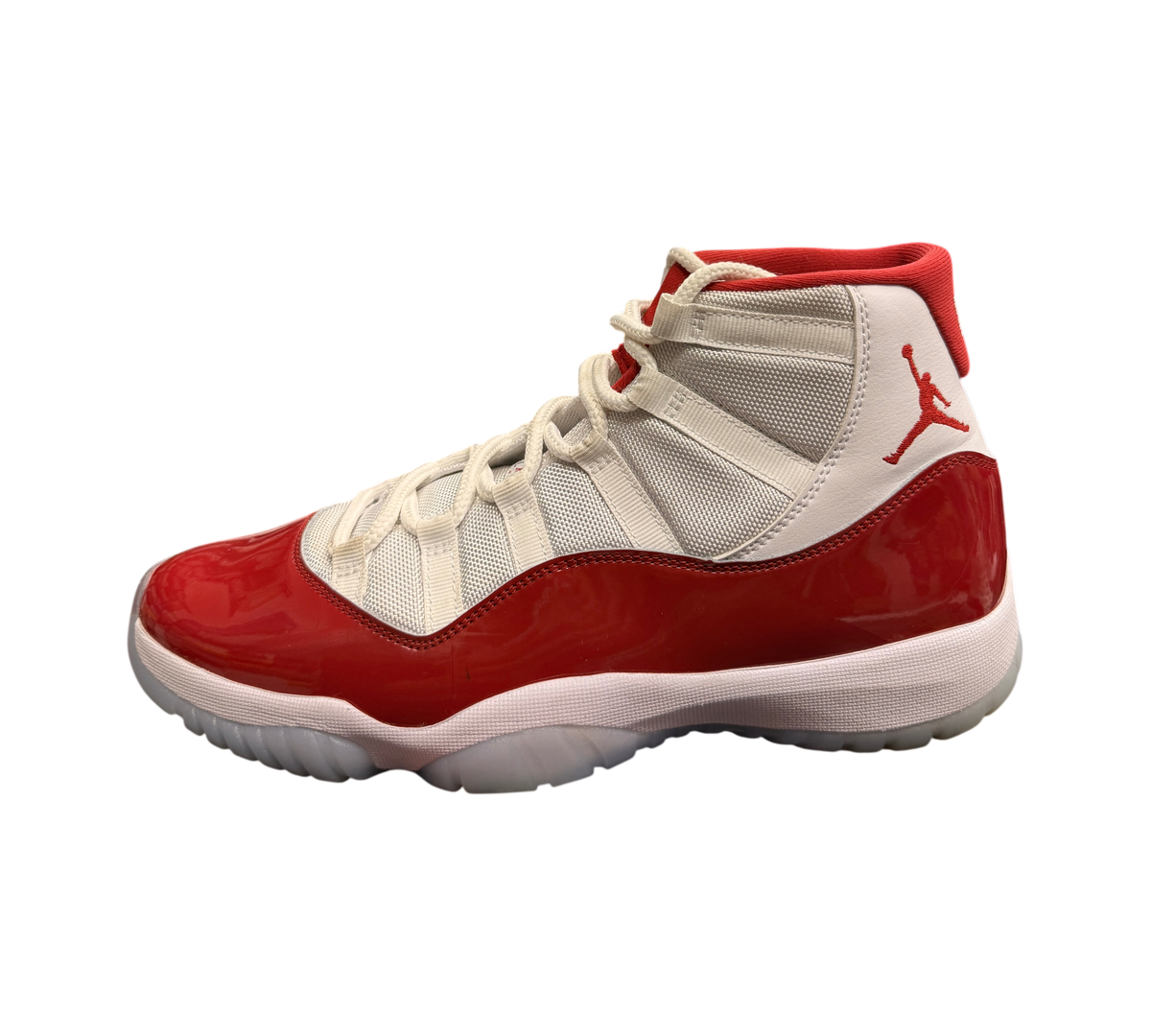Genesis Boutique pre-owned Jordan 11 Cherry sneakers featuring white mesh, red patent leather, and a translucent sole.