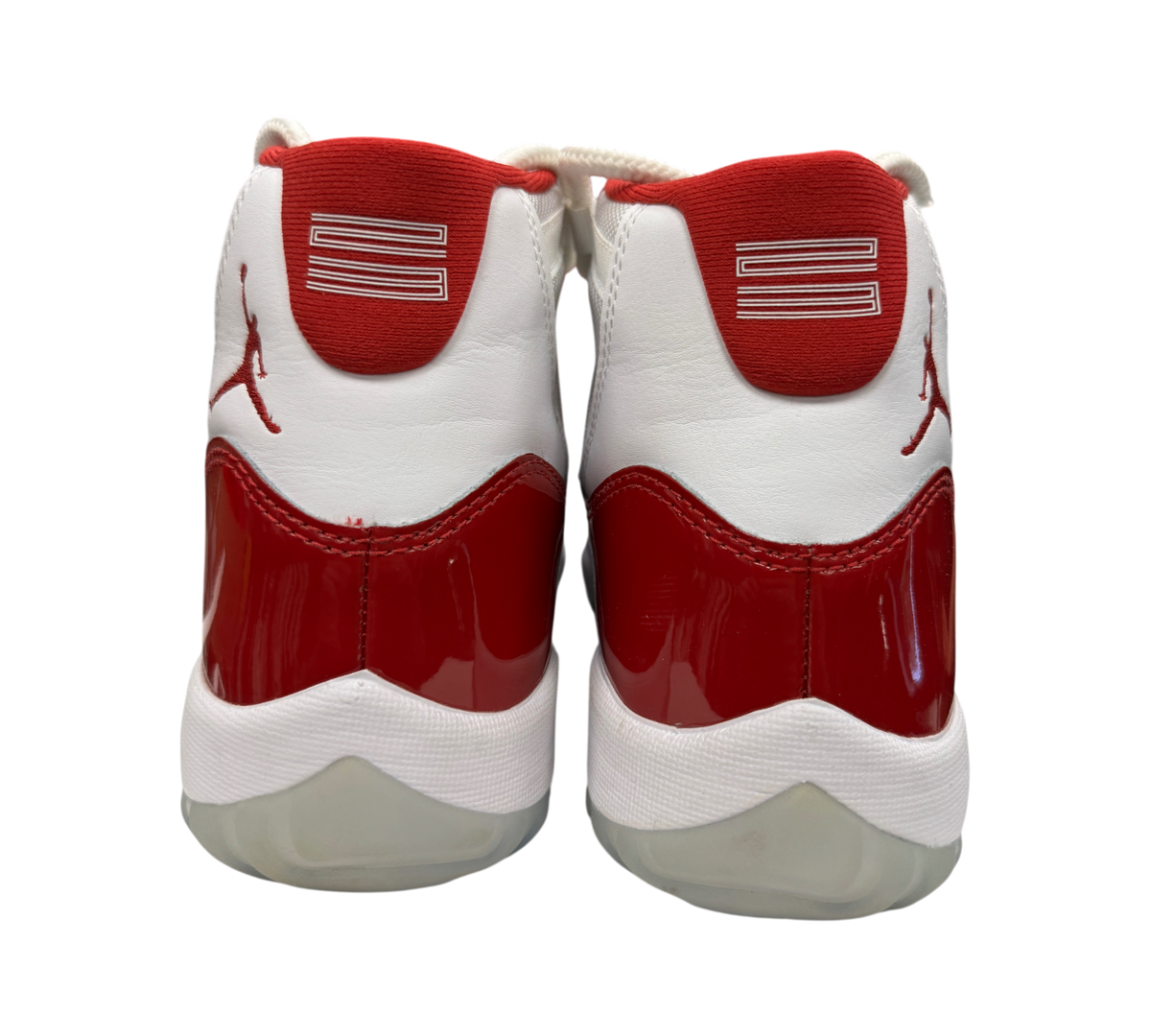 Genesis Boutique Jordan 11 Cherry sneakers showing the white and red patent leather heel view with Jumpman logo