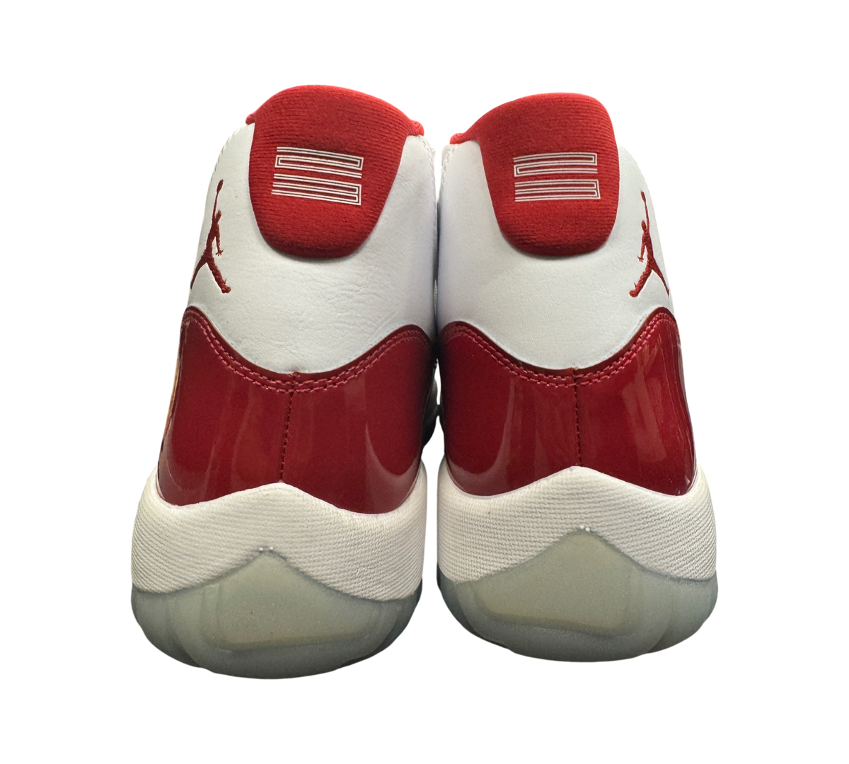 Genesis Boutique Jordan 11 Cherry sneakers showing the white and red patent leather heel view with Jumpman logo