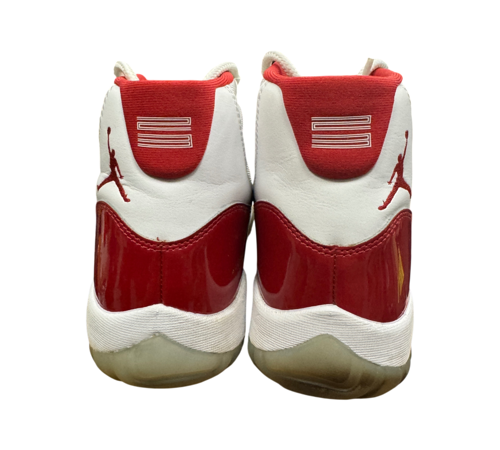 Genesis Boutique Jordan 11 Cherry sneakers showing the red patent leather heel and Jumpman logo from the back view
