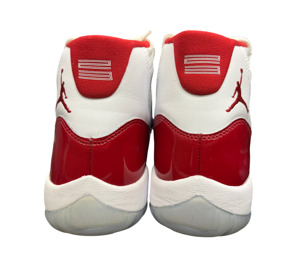 Genesis Boutique Jordan 11 Cherry sneakers showing the white and red patent leather heel view with Jumpman logo