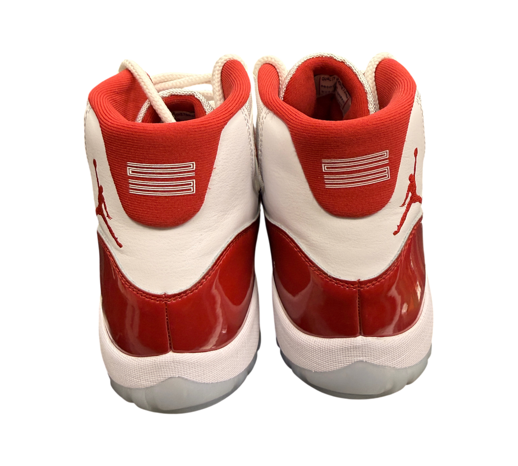 Genesis Boutique pre-owned Jordan 11 Cherry sneakers featuring white leather, red patent leather, and Jumpman logo.