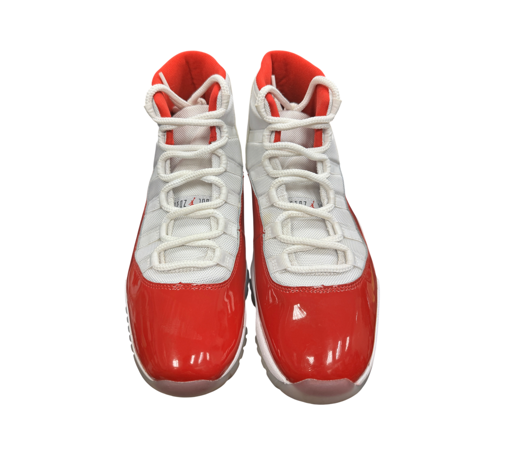 Genesis Boutique Jordan 11 Cherry sneakers featuring white mesh uppers and glossy red patent leather mudguards