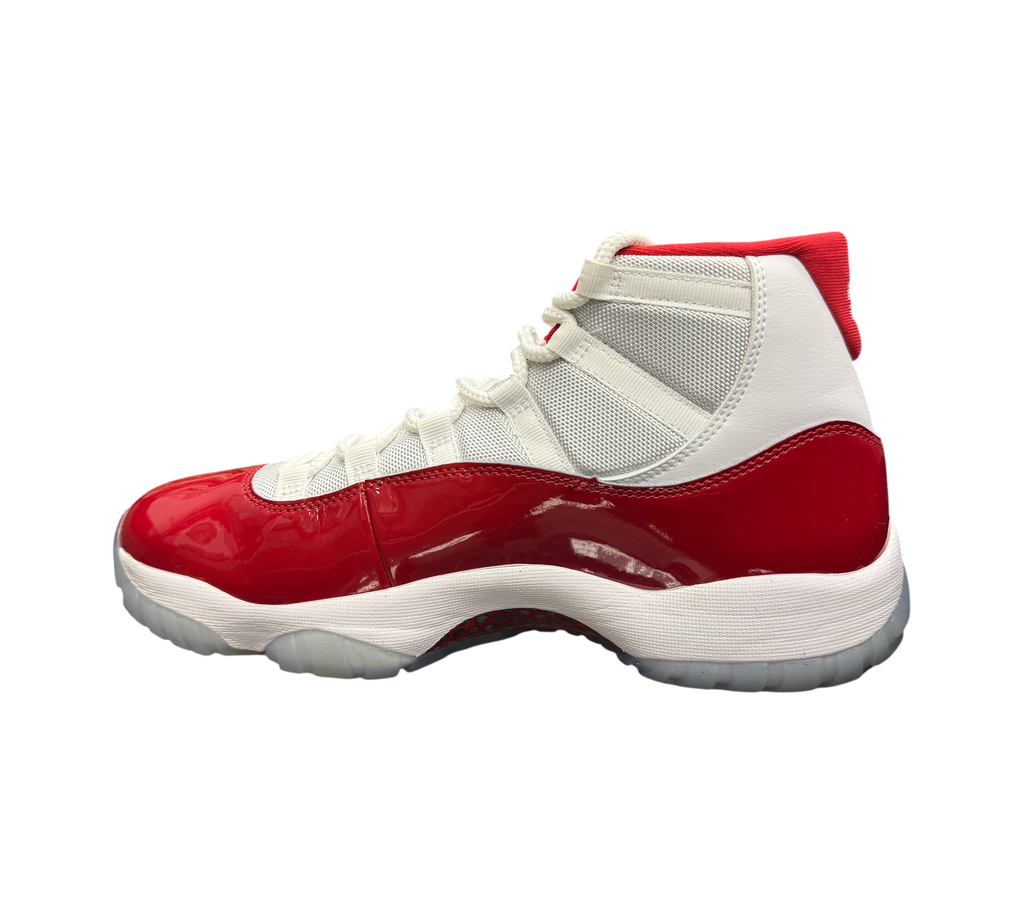 Genesis Boutique Jordan 11 Cherry sneakers featuring white mesh upper and glossy red patent leather mudguard