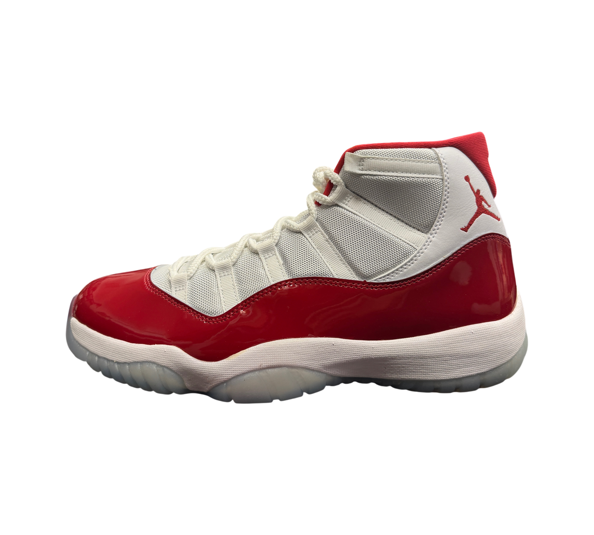 Genesis Boutique Jordan 11 Cherry sneakers featuring white mesh, red patent leather mudguard, and Jumpman logo.