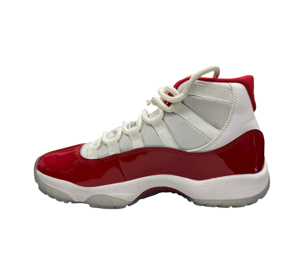 Genesis Boutique Jordan 11 Cherry sneakers featuring white mesh upper, red patent leather mudguard, and icy outsole.