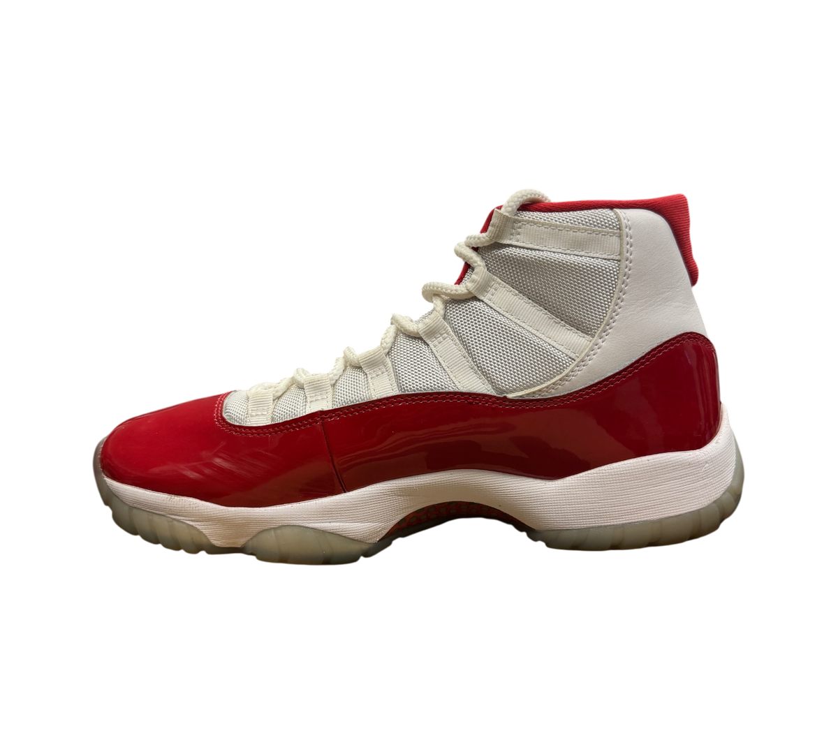 Genesis Boutique Jordan 11 Cherry sneakers featuring white mesh and red patent leather side profile view