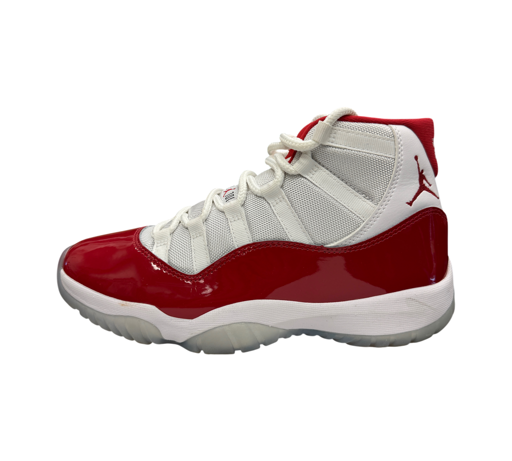 Genesis Boutique Jordan 11 Cherry sneakers featuring white mesh upper and glossy red patent leather mudguard