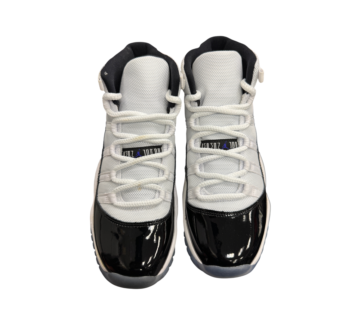 Genesis Boutique Jordan 11 GS Concord sneakers featuring white mesh uppers and black patent leather mudguards.