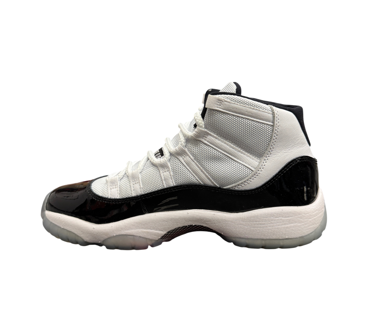 Genesis Boutique Jordan 11 GS Concord sneaker in white and black patent leather with a translucent outsole