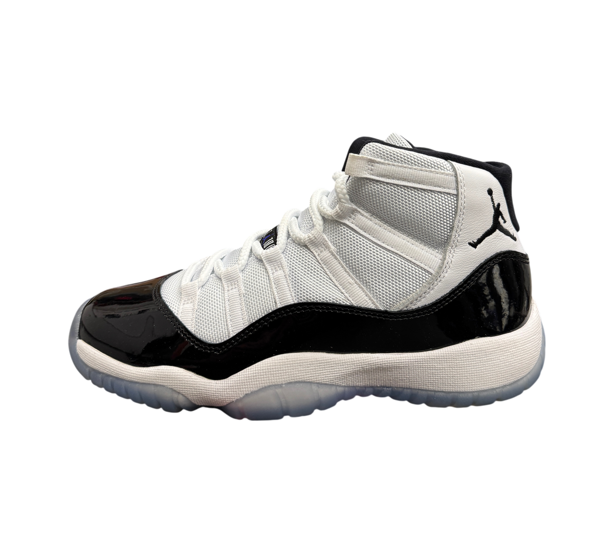 Genesis Boutique Jordan 11 GS Concord sneaker featuring white mesh upper, black patent leather mudguard, and icy outsole