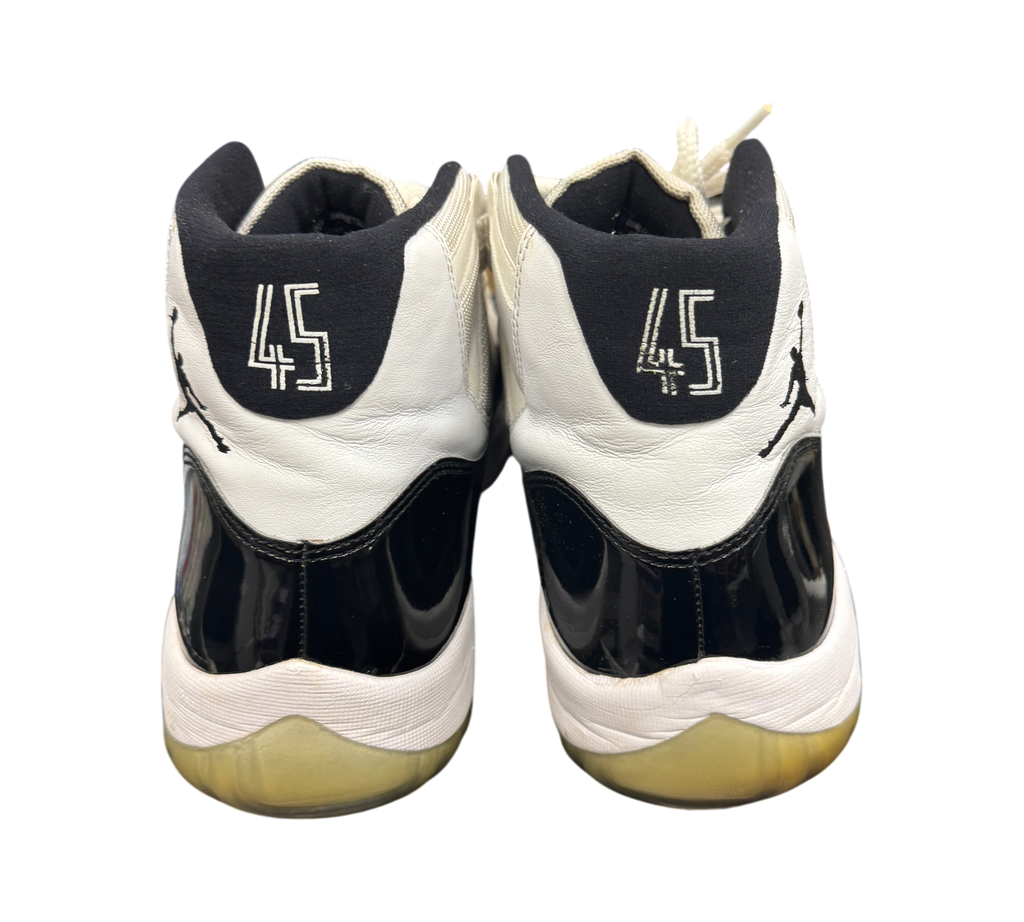 Genesis Boutique used Jordan 11 Concord sneakers showing the back heels with 45 embroidery and black patent leather
