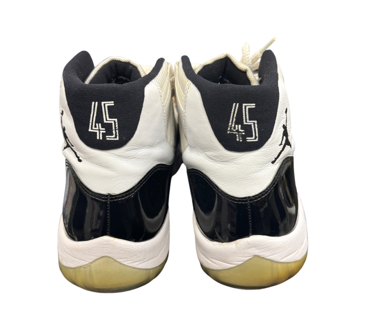 Genesis Boutique used Jordan 11 Concord sneakers showing the back heels with 45 embroidery and black patent leather