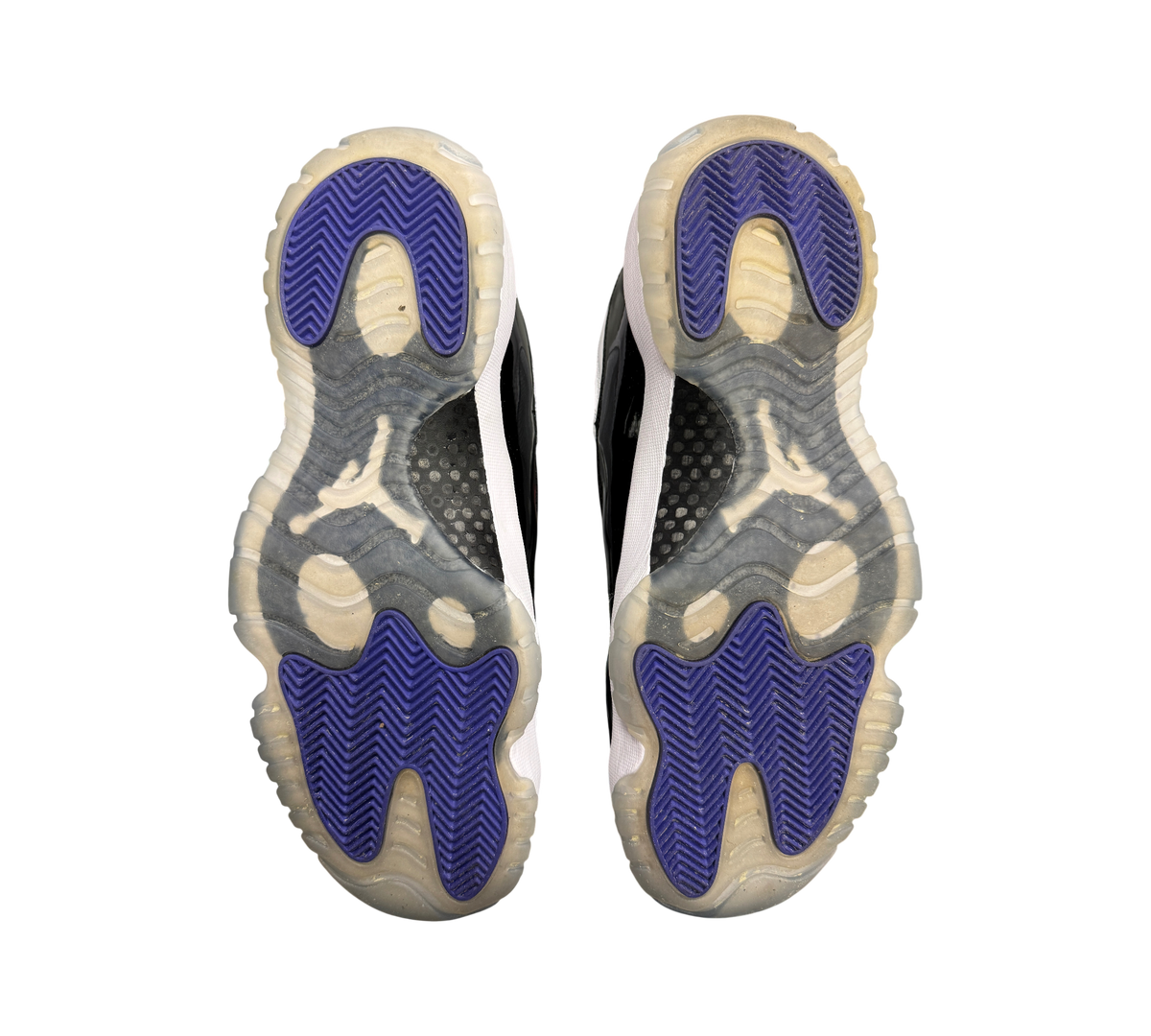 Genesis Boutique used Jordan 11 Concord sneakers showing purple and translucent rubber outsoles with Jumpman logo